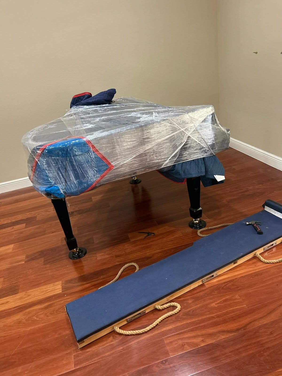 Professionally stretch-wrapped furniture protected with padding and moving straps